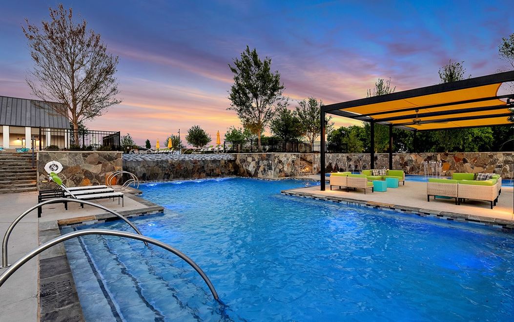 Pool with cabana during dusk at The Grove Frisco