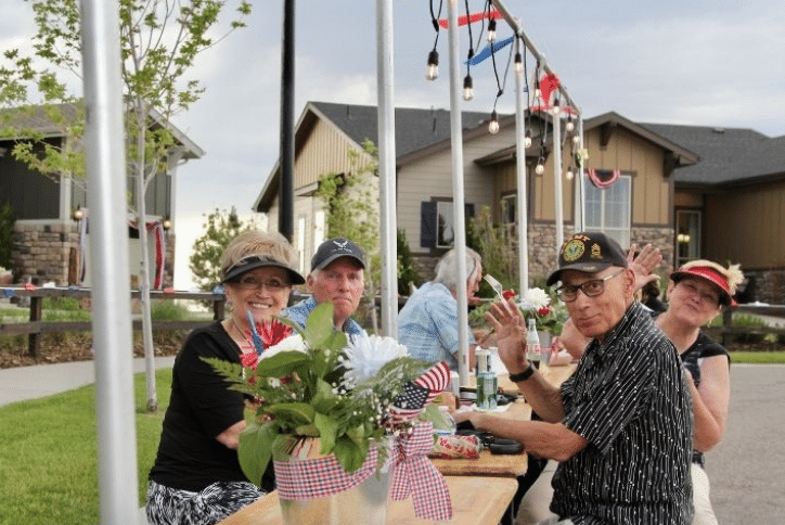 Military Veterans eating at a table at Inspiration Hilltop Block Party