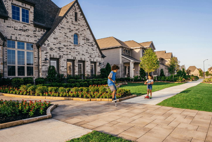 Kids playing on the sidewalk in front of new homes at Elyson