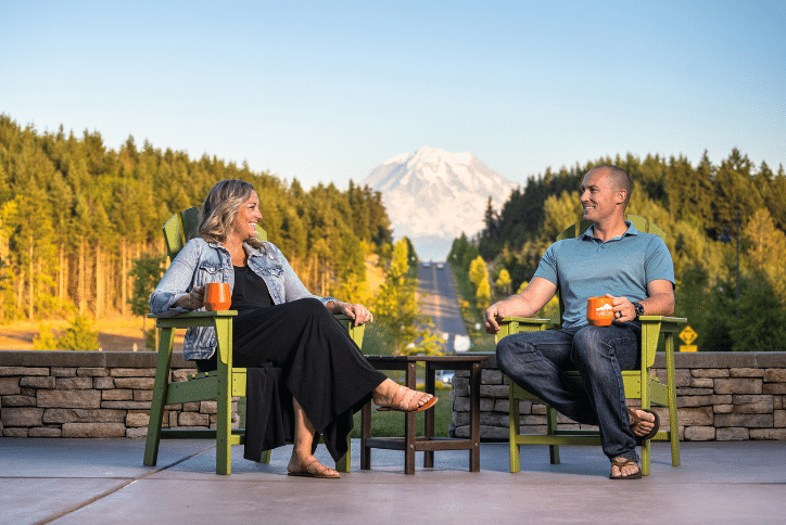 Couple drinking coffee at Tehaleh in front of view of Mt Rainier